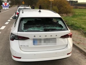 samochód skoda z rozbitą szyba tylna i boczna lewą zaparkowany na poboczu, przed nim inny pojazd