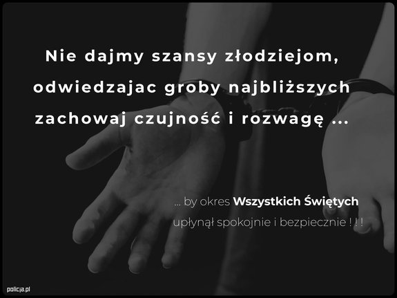 dłonie skute w kajdanki na ciemnym tle