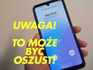 telefon komórkowy trzymany w dłoni. Żółty napis, uwaga, to może być oszustwo